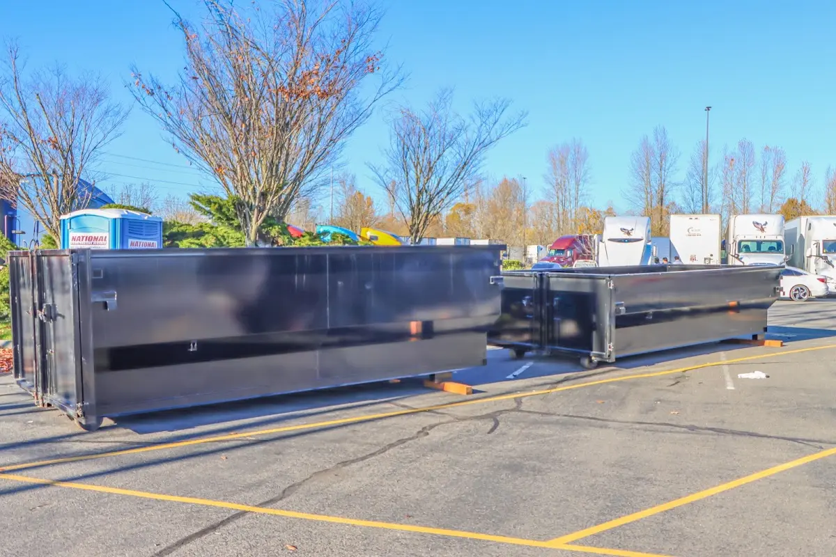 Professional dumpster rental service with roll-off container on residential driveway in St. Matthews